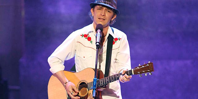 michael grimm playing guitar on stage at americas got talent