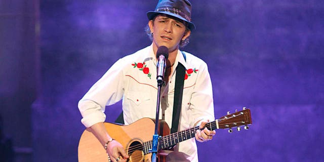 michael grimm playing guitar on stage at americas got talent