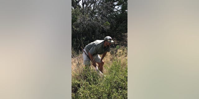 Dr. JoVonn Hill looking at grasshoppers