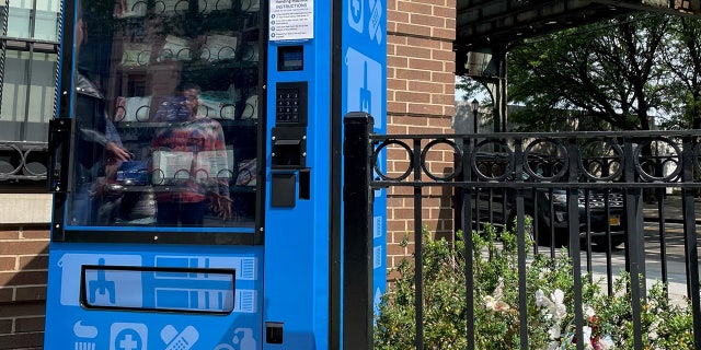 A blue vending machine offering free drug paraphernalia for users to avoid ODs t