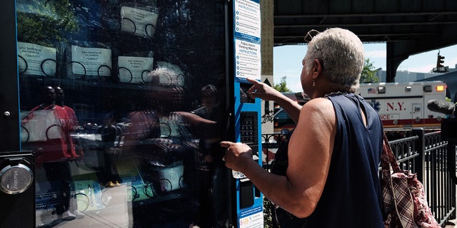 A woman uses the Narcan vending machine installed in Brooklyn