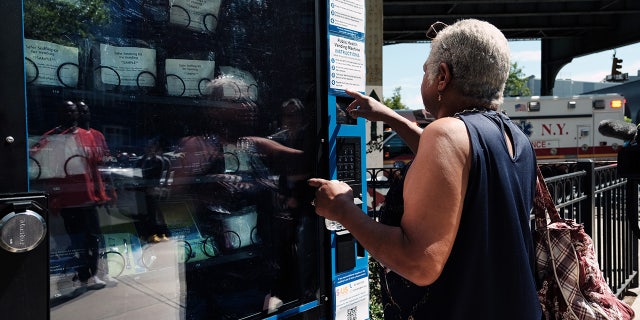 A woman uses the Narcan vending machine installed in Brooklyn