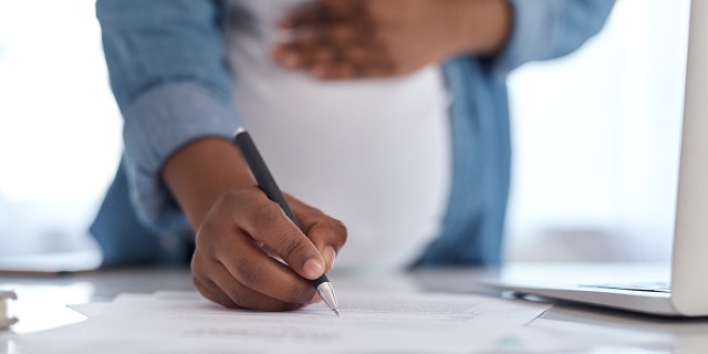 pregnant woman writing