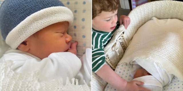 Ernest in a crib wearing a blue cap split August in a green striped shirt saying hi to baby Ernest in his cradle