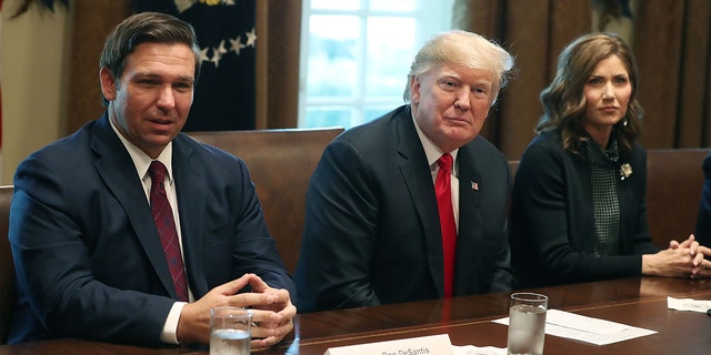 Ron DeSantis, Donald Trump, and Kristi Noem sit next to each other at the White House