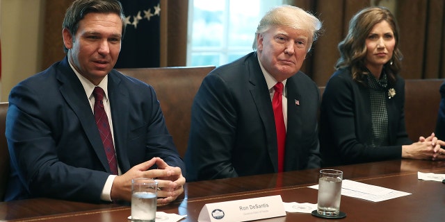 Ron DeSantis, Donald Trump, and Kristi Noem sit next to each other at the White House