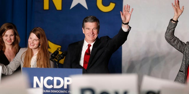 Roy Cooper waves