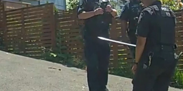 police holding samurai sword