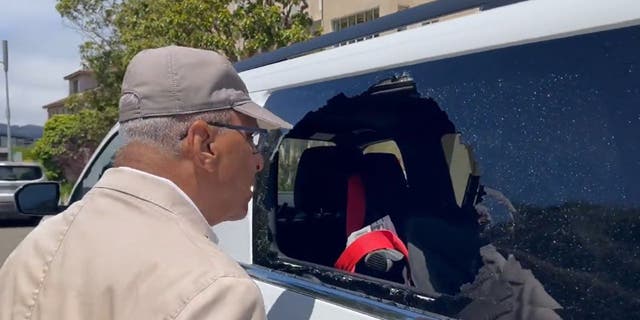 Shelby Steele looking into his car