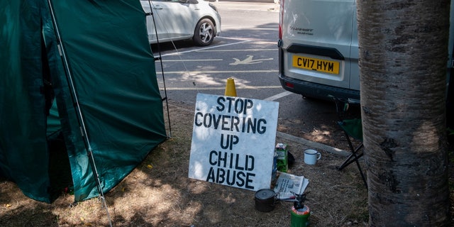 "stop covering up child abuse" sign outside Tavistock clinic
