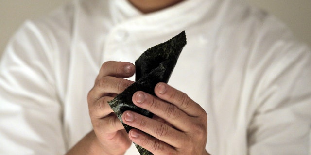 A chef preparing temaki