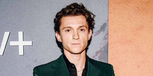 Tom Holland wears green velour suit on red carpet