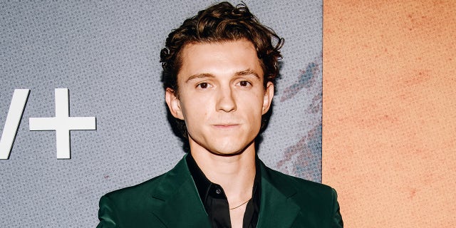 Tom Holland wears green velour suit on red carpet