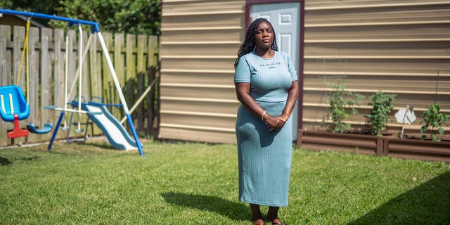 woman outside her home in Donaldsonville