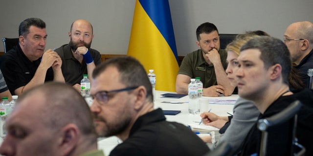 Zelenskyy at conference table with other officials