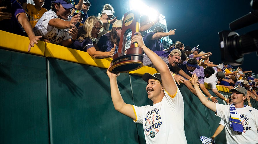 ESPN television crew takes video of the trophy during the NCAA