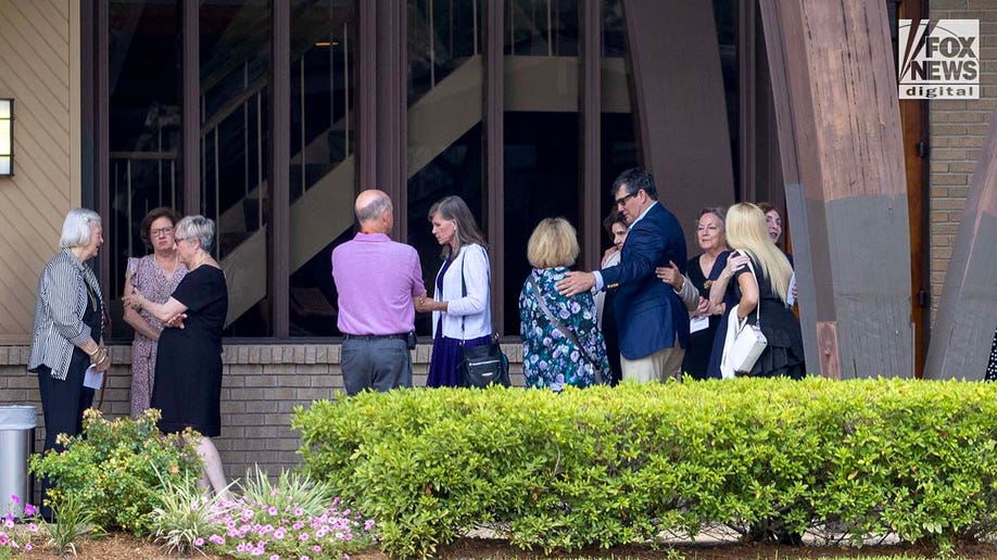 Family and friends of Cameron Robbins arrive to the memorial service