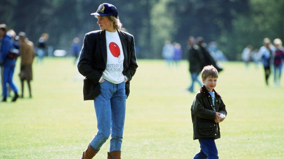 Princess Diana in jeans and a crewneck next to Prince Harry