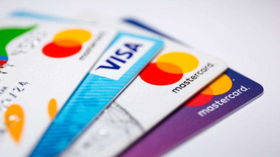 In this photo illustration a Visa credit card and Mastercard debit cards are seen displayed.