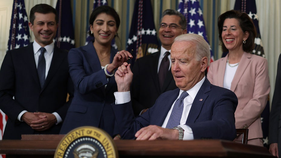 FTC chair hands Biden a pen