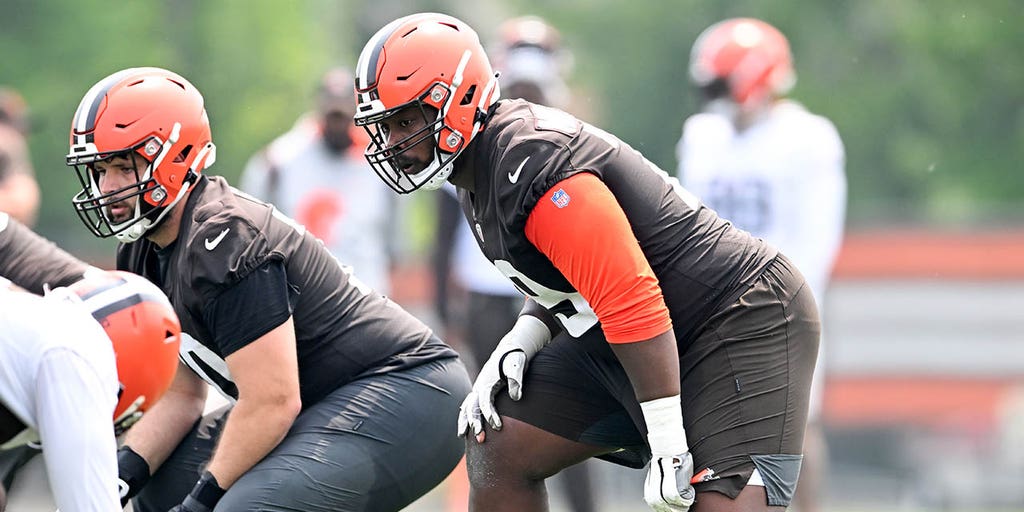 A member of the Cleveland Browns training staff leaves the field