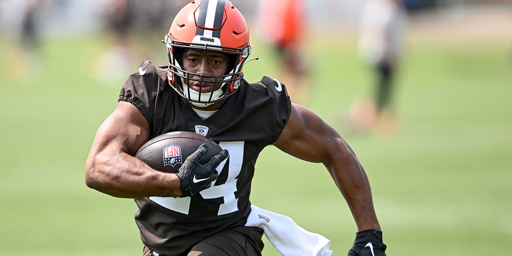 New York Giants' Saquon Barkley receiving support from Nick Chubb