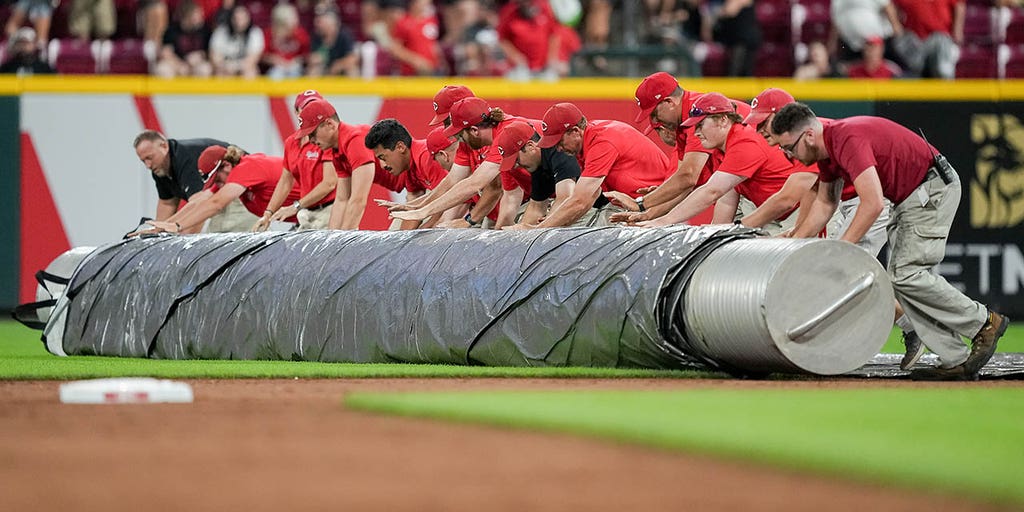 TarpGuy gets pulled under when grounds crew rolls field cover at