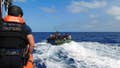 Members of the Coast Guard intercept a boat carrying Cuban migrants.