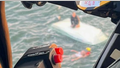 The U.S. Coast Guard responds to a capsized 16-foot boat offshore of Jekyll Island in Georgia on July 23. Officials say two men were rescued. This image was taken from the cockpit of a helicopter.