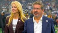 Washington Commanders owners Tanya Snyder, left, and Dan Snyder on the field before the Dallas Cowboys defeat of the Washington Commanders  25-10 at AT&amp;amp;T Stadium on October 2, 2022 in Arlington, TX.