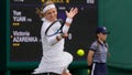 Victoria Azarenka of Belarus plays a return to China's Yuan Yue during the first round women's singles match on day one of the Wimbledon tennis championships in London, Monday, July 3, 2023.