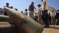 Activists and international delegations stand next to cluster bomb units, during a visit to a Lebanese military base at the opening of the Second Meeting of States Parties to the Convention on Cluster Munitions, in the southern town of Nabatiyeh, Lebanon