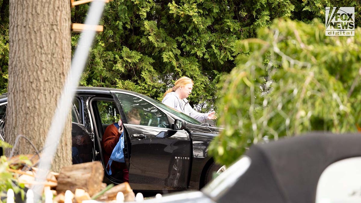 Asa Ellerup enters her home in Long Island