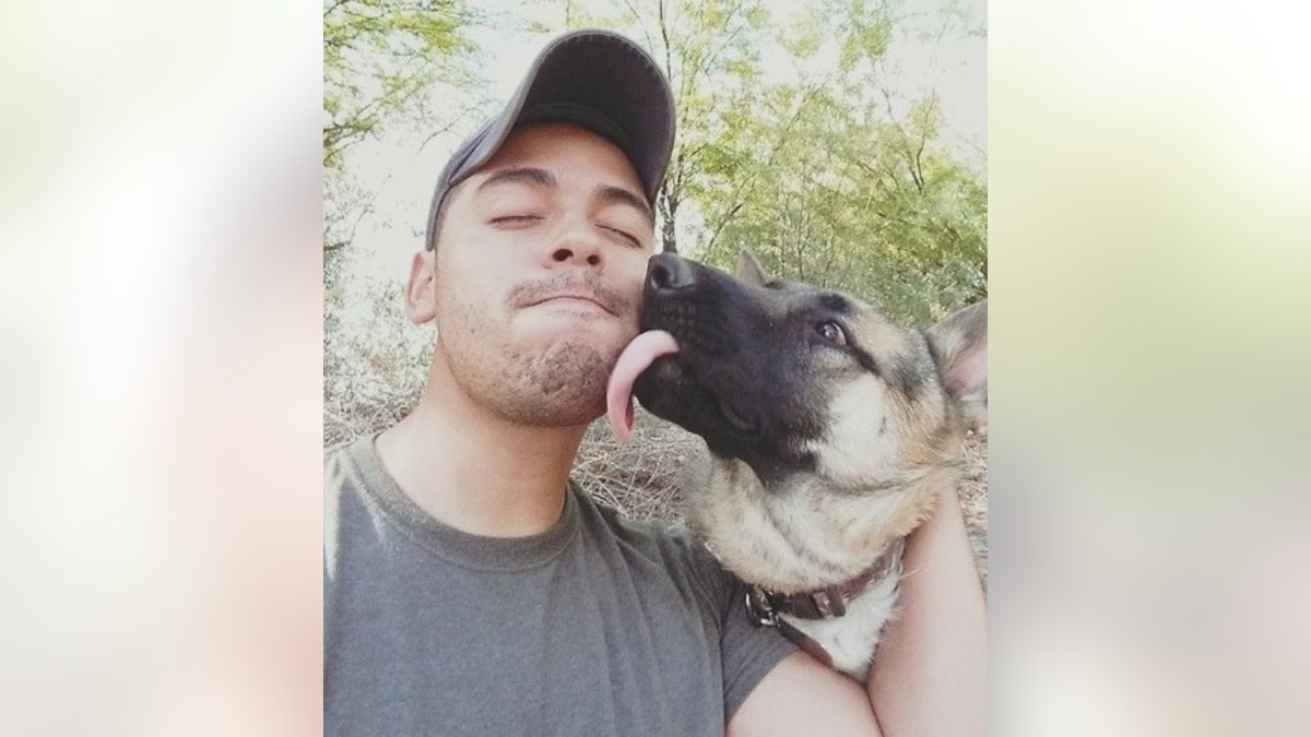 Kevin McKenna poses next to his dog