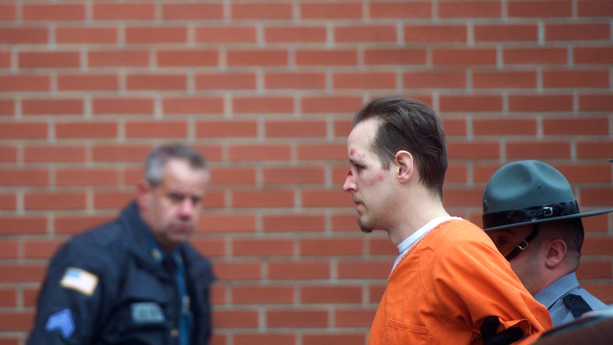 Eric Matthew Frein is taken by police officers into Pike County Courthouse for an arraignment in Milford, Pennsylvania