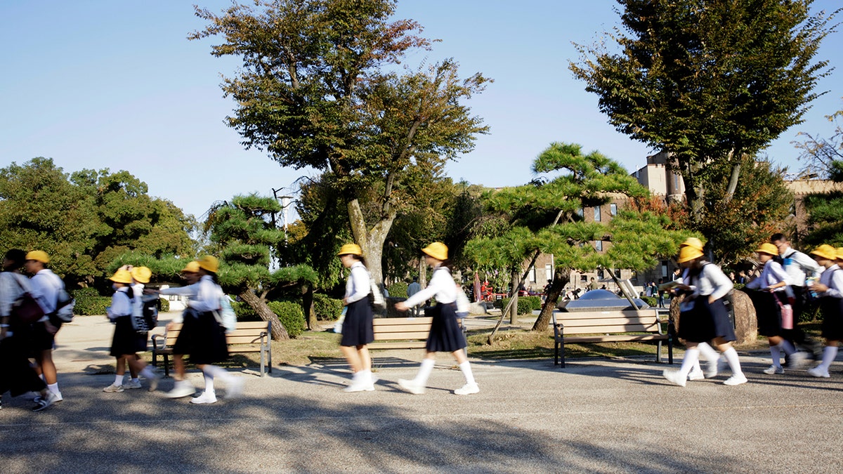 School children walk on a day tour of the Osaka Castle October 26, 2017. 