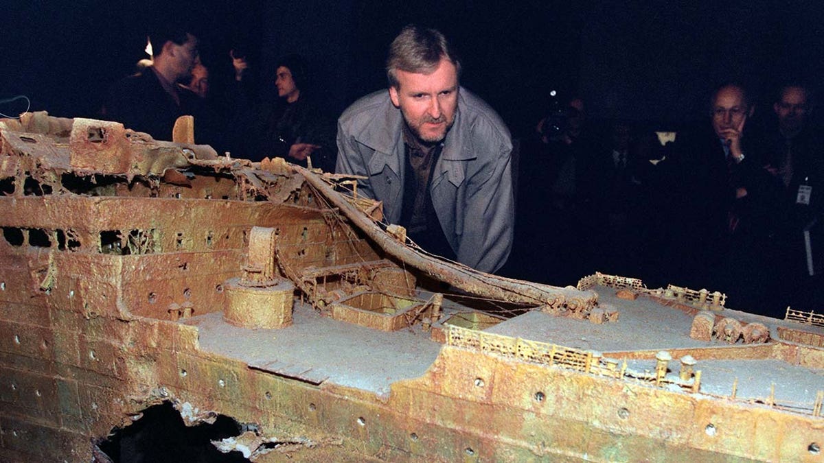 James Cameron looking at a model of the Titanic wreckage