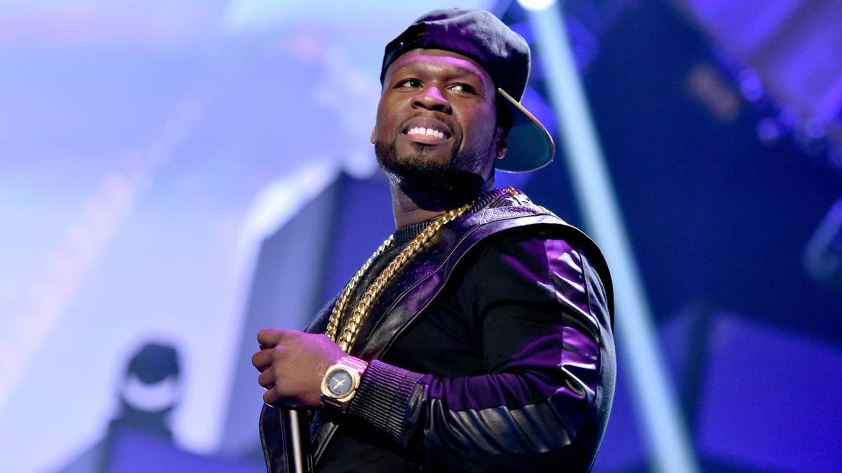 50 Cent performing with baseball cap