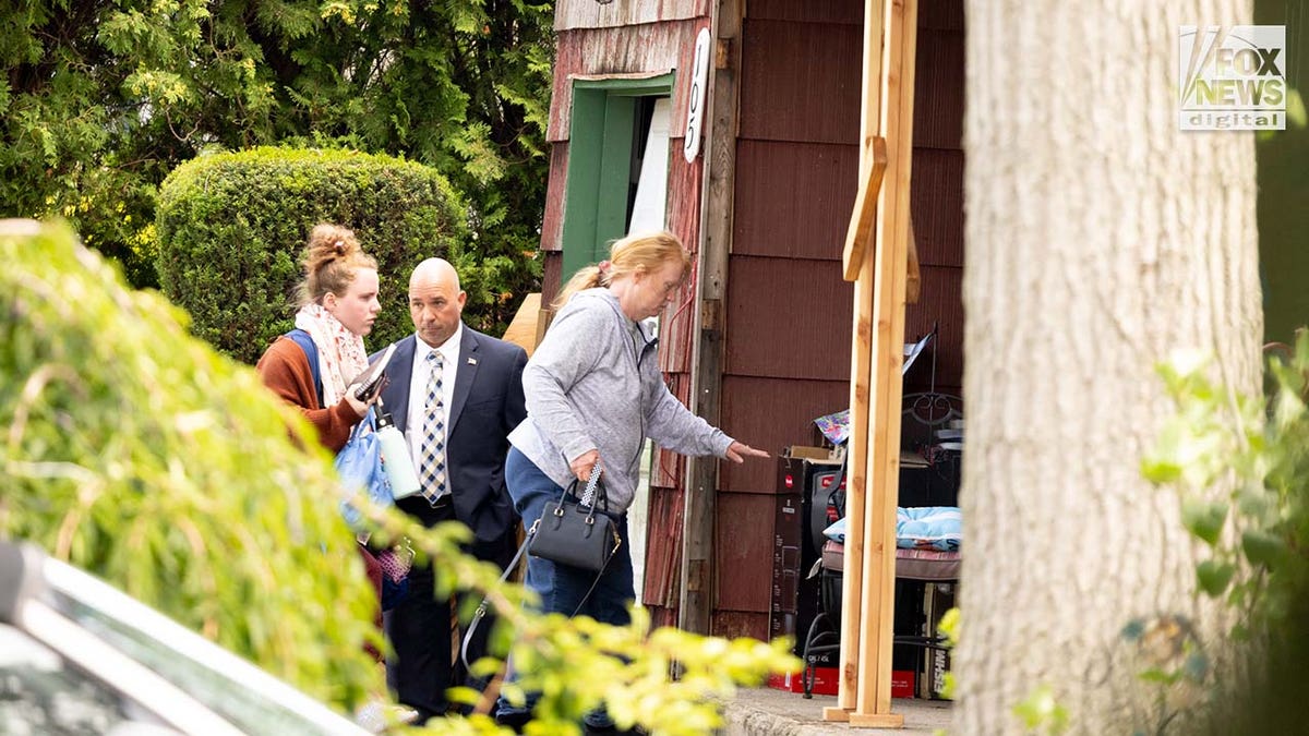 Asa Ellerup and Victoria Heuermann enter their home in Long Island