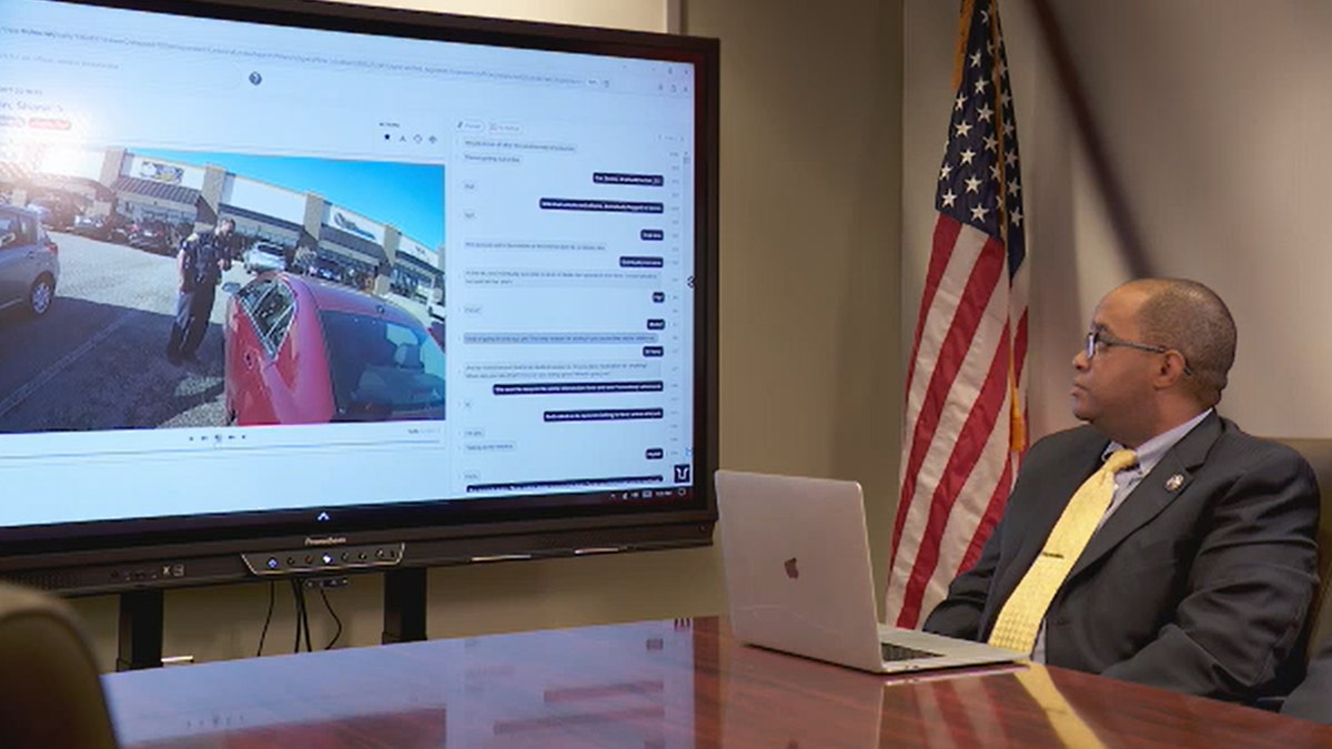 Officer sitting at a desk monitoring footage