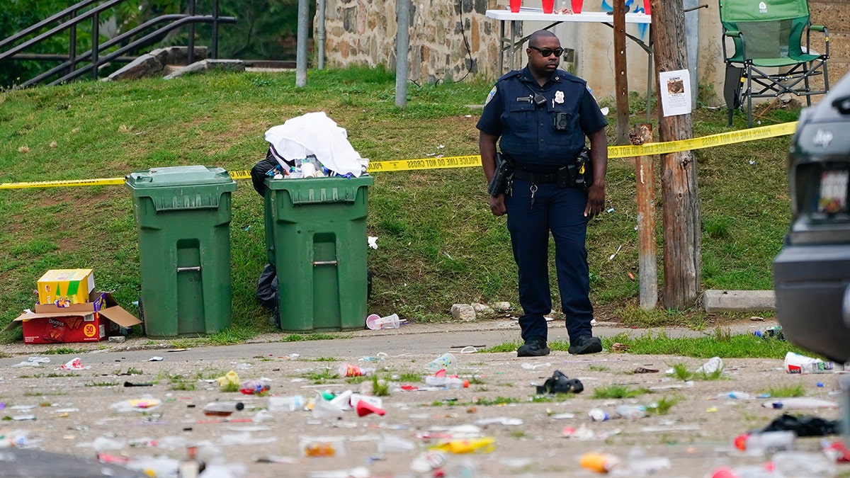 Trash cans, police officer