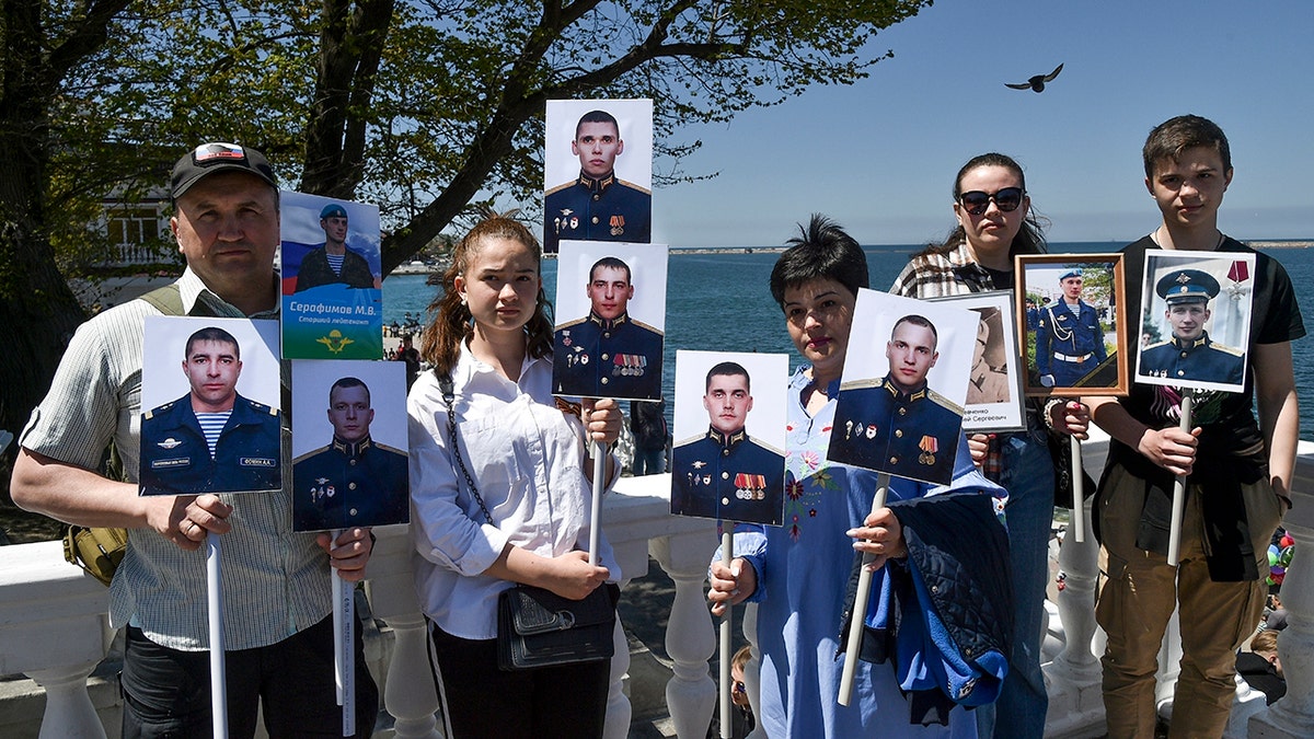 People holding photos