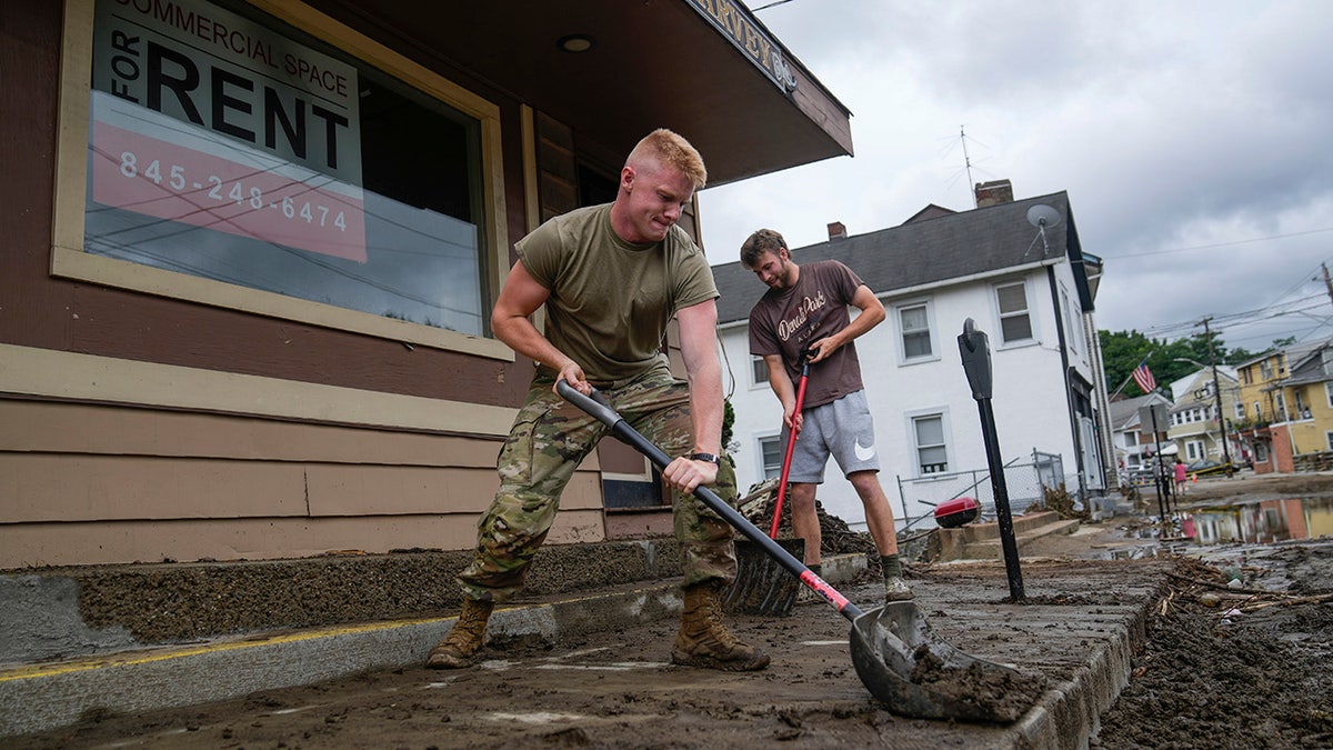 Volunteers help clear Main Street of debris after floodwaters subsided Monday, July 10, 2023, in Highland Falls, New York.