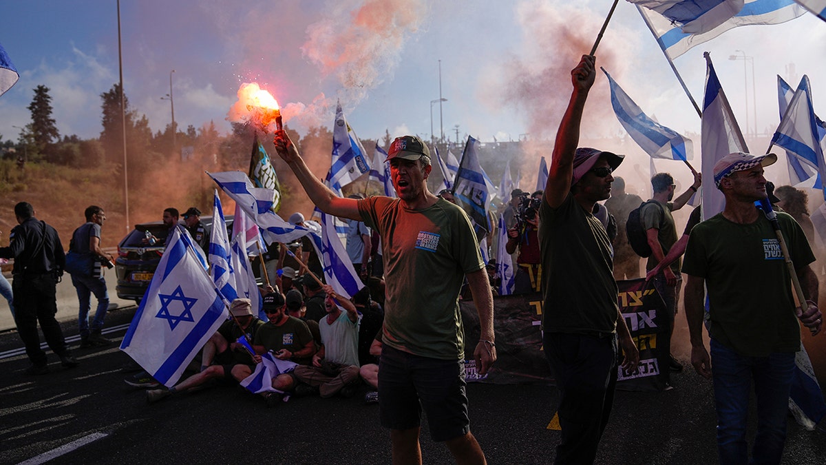 Demonstrators block a highway leading to Jerusalem