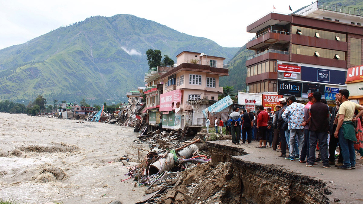 People stand by a road 