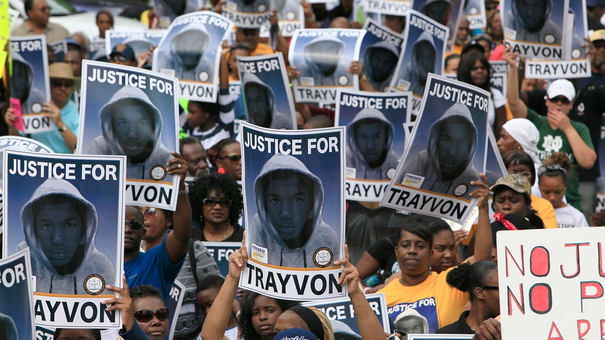 Protesters holding signs