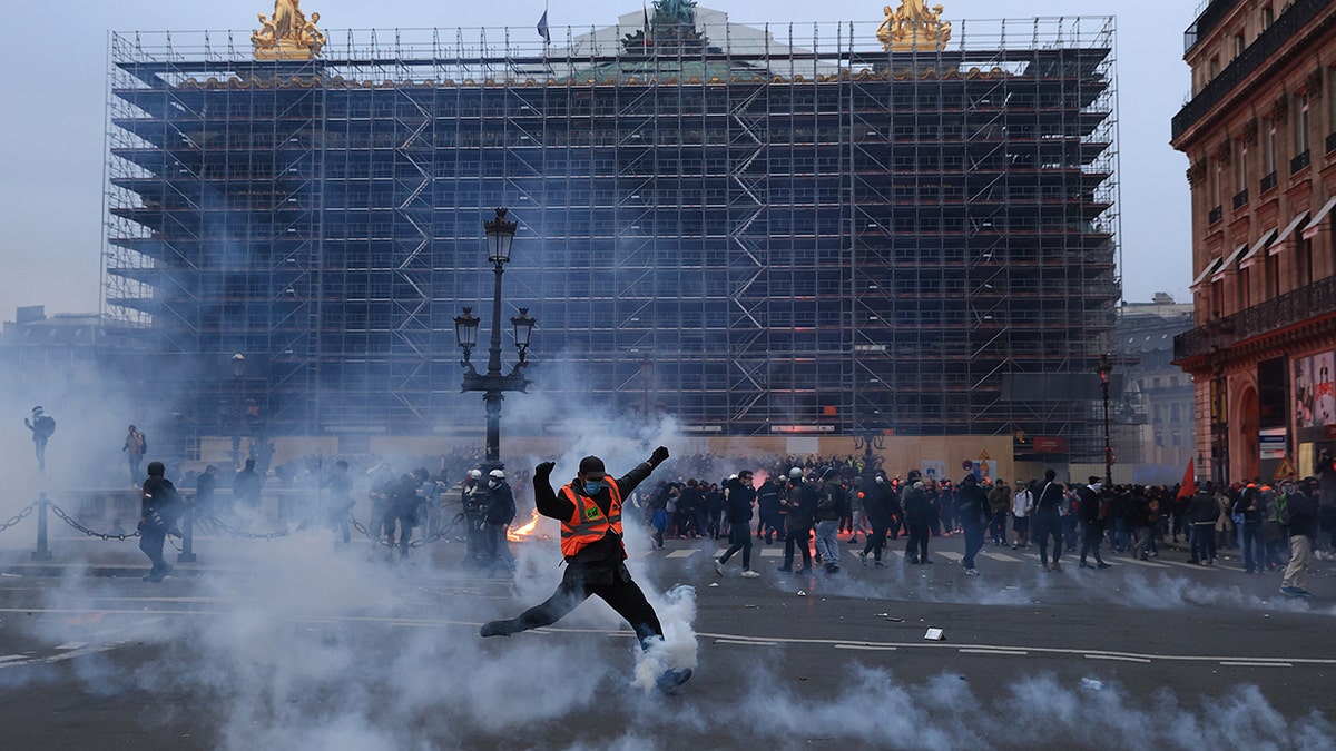 A protester kicks a tear