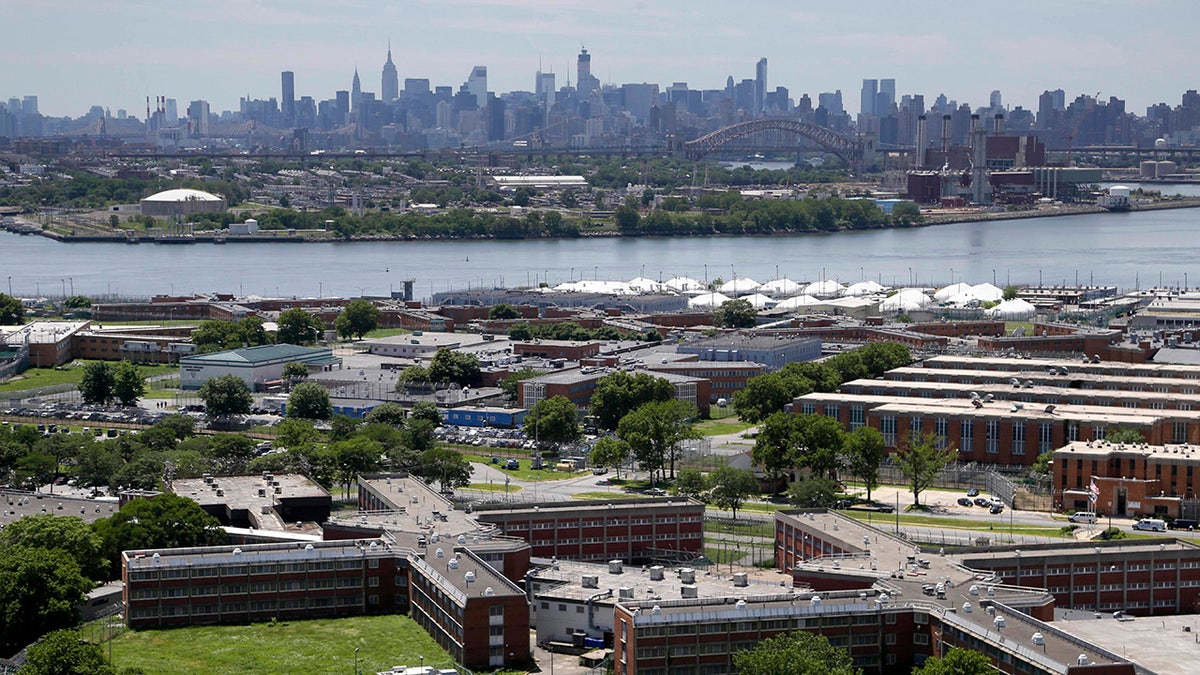 Rikers Island jail complex with NYC skyline