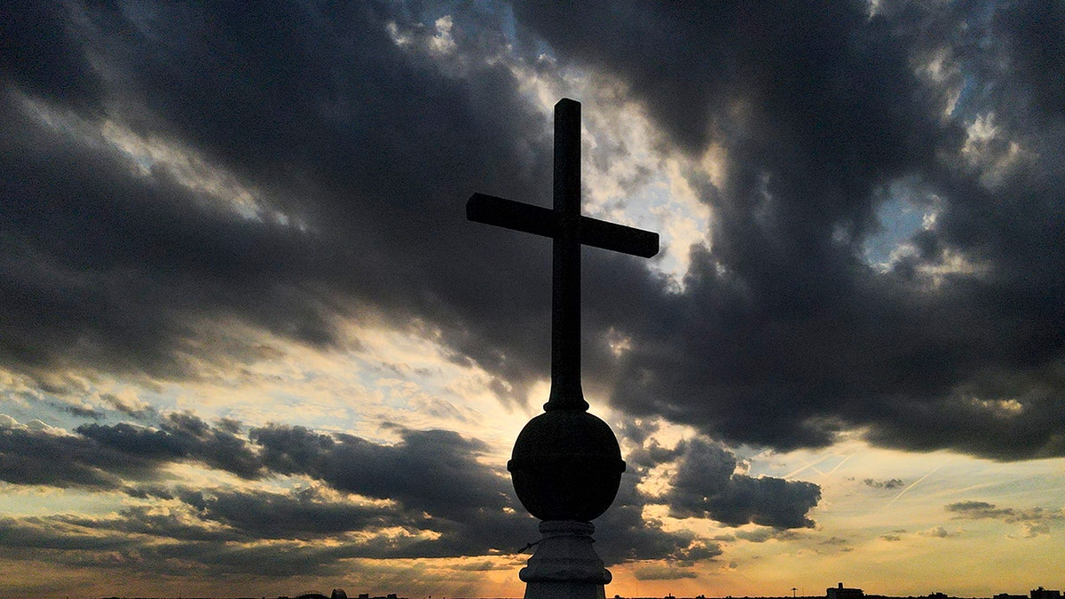 A cross is seen on top of the steeple 