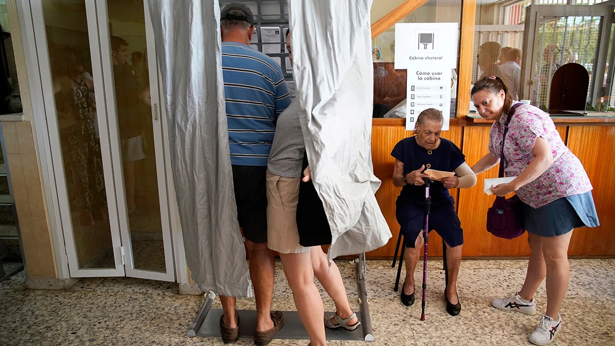 A Spanish couple in a voting booth